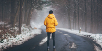 Person standing in a gloomy forest