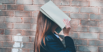 Image of woman with face in book